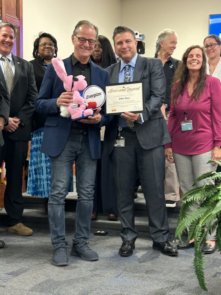 Peter Pucci receives the Energizer Bunny Award from Dr. Patty Salelens and Michael Bell Supervisor