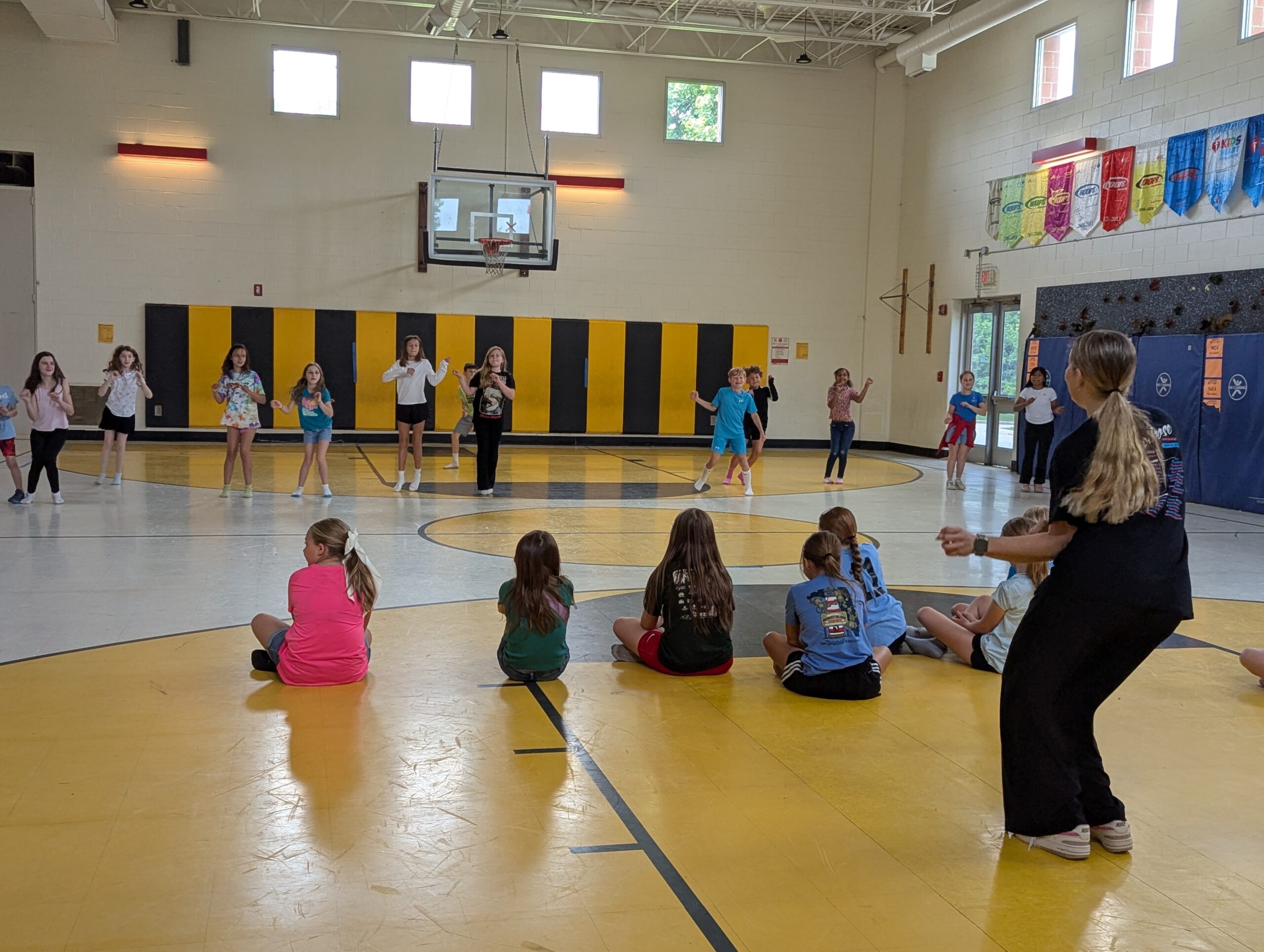 Gabby teaching 3rd -5th graders movement dance sequences in the Kennard Elementary School gymnasium.