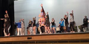 West African Dance Teacher Sylvia Soumah leading QACHS students and drummers during class.