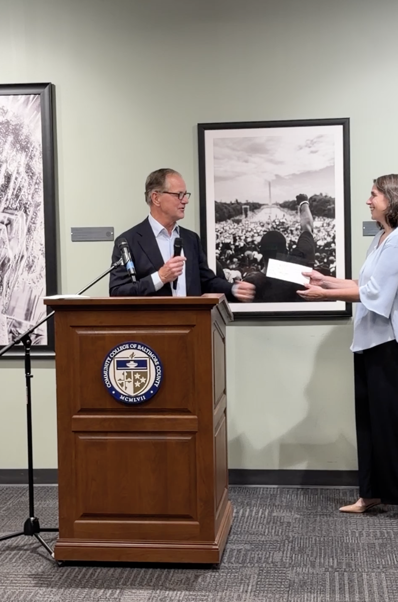 Peter Pucci gives the donation for the Carole Drake Cascio Dance Ccholarship to Melinda Blomquist.